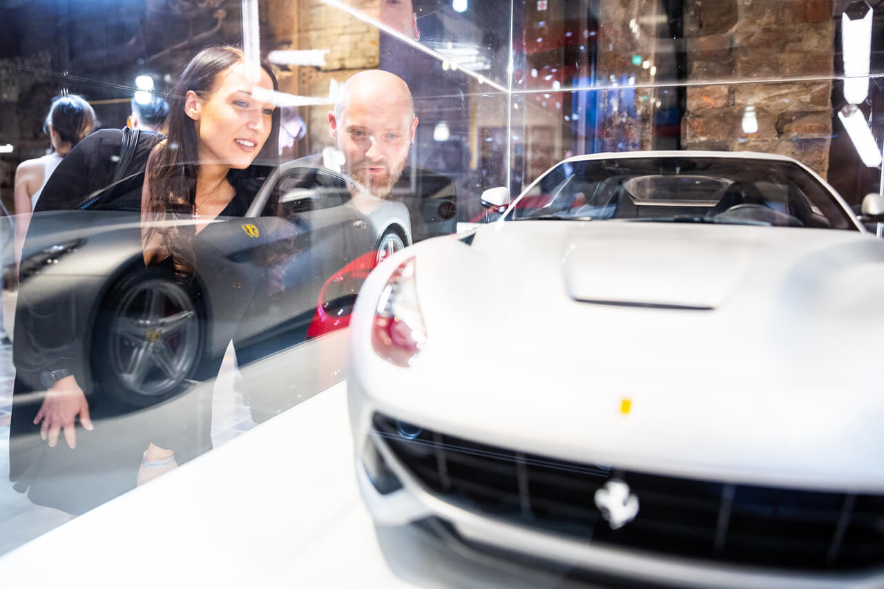 Visitors in front of a Ferrari model